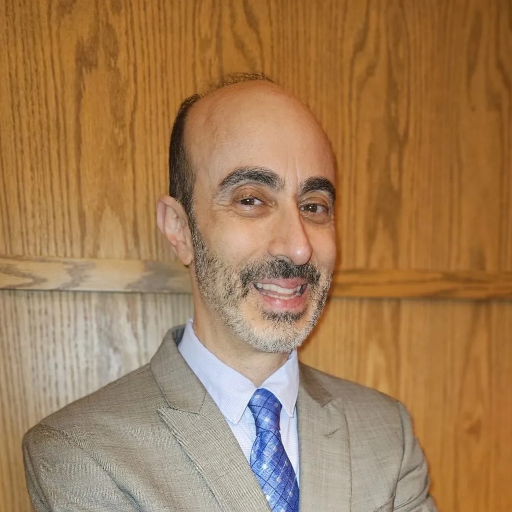 A man with a beard and mustache wearing a suit.