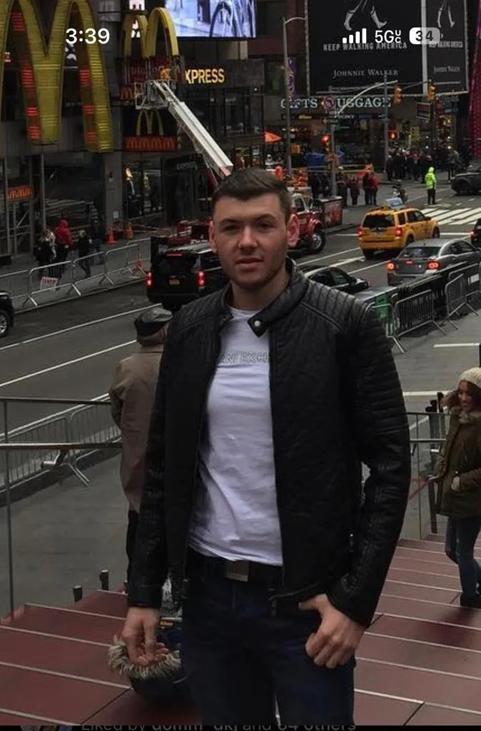 A man standing on the side of a street.